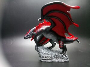 Black and red wyvern sculpture commissioned for a gift, marked with a name